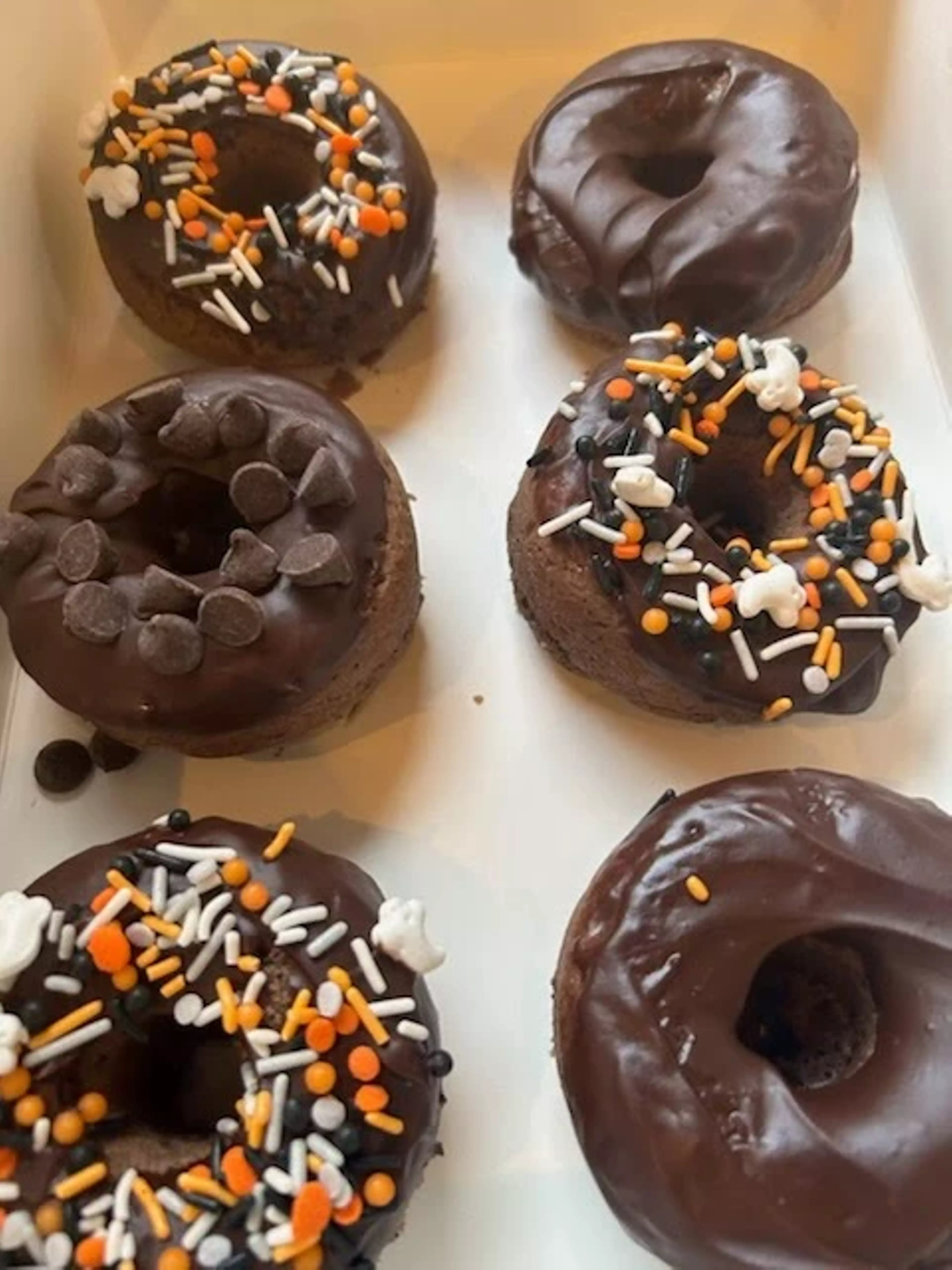 A box full of specialty Halloween themed donuts.